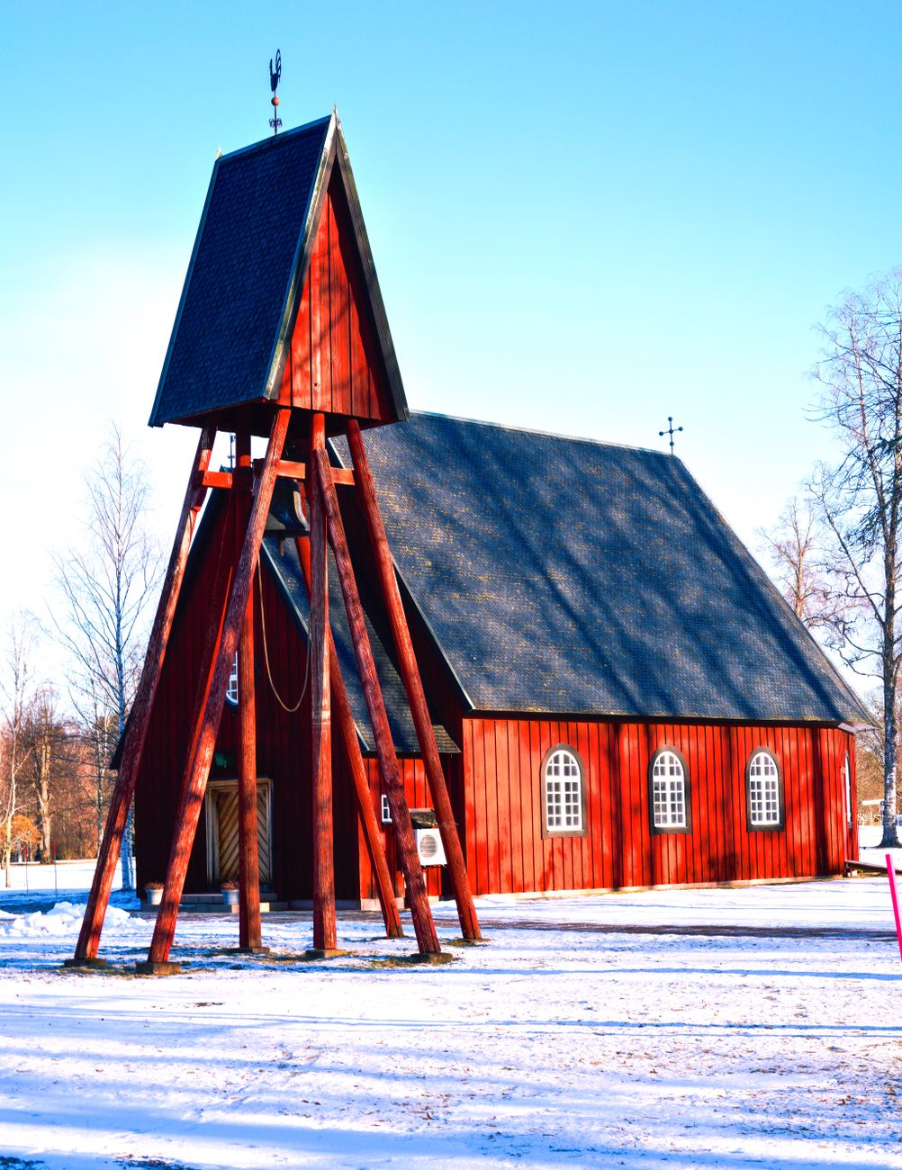 traditional swedish red wooden church in snow